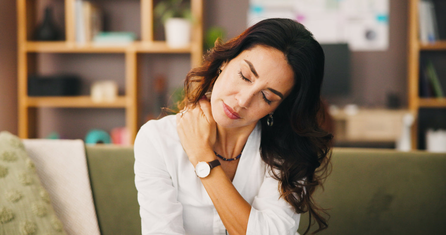 A photo of a woman massaging her neck pain